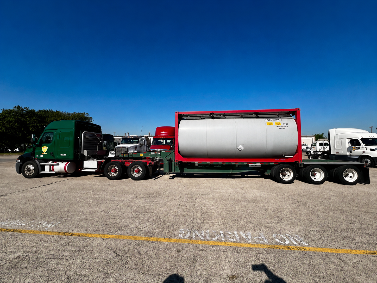 Palletized tank chassis load on flatbed trailer