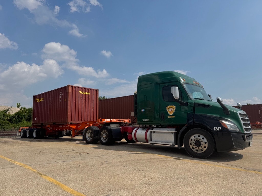 Palletized truck hauling 20' container on triaxle chassis