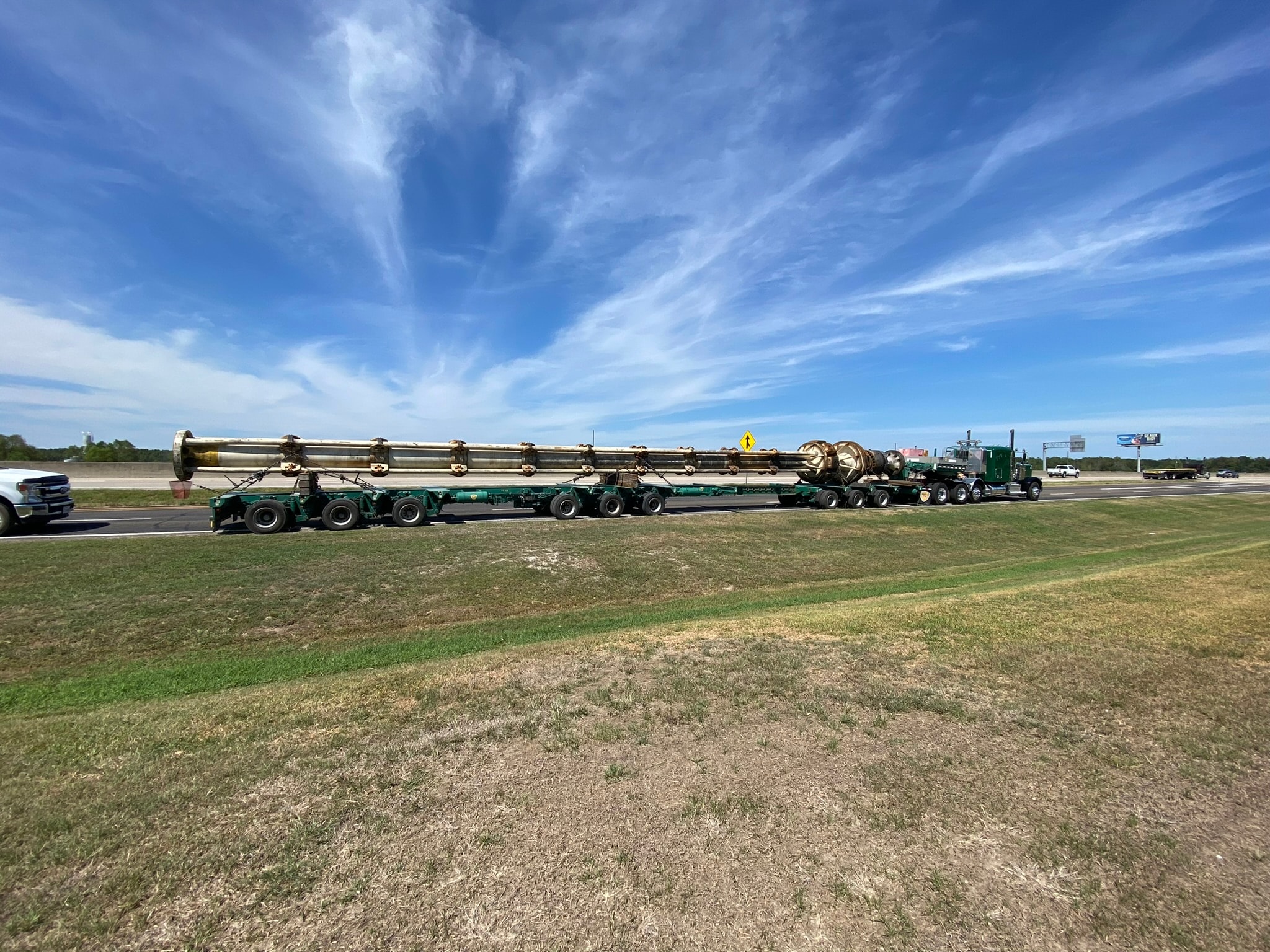 Palletized oversized pipe column on multi-axle stretch trailer on Texas highway