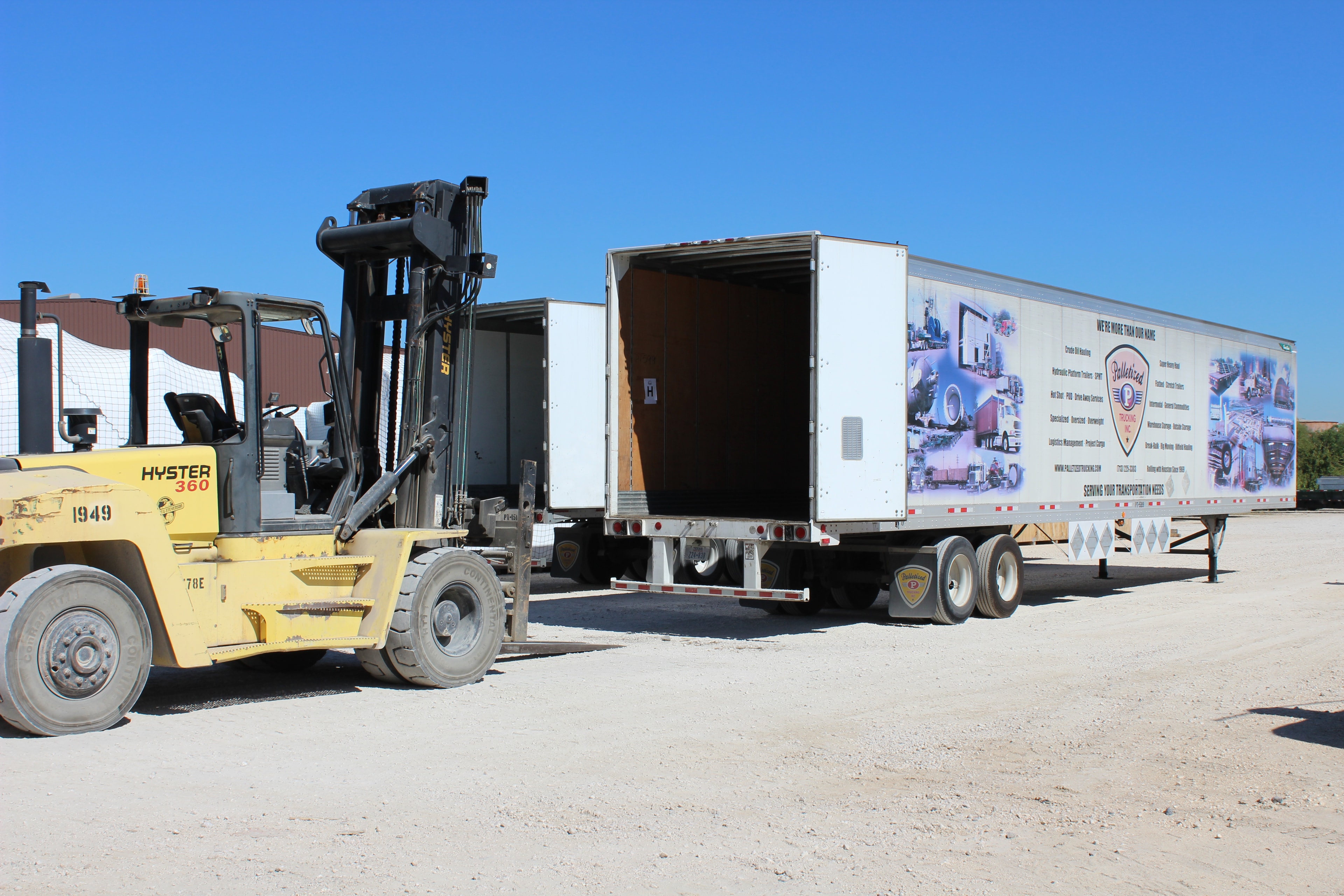 Hyster forklift loading a Palletized dry van trailer